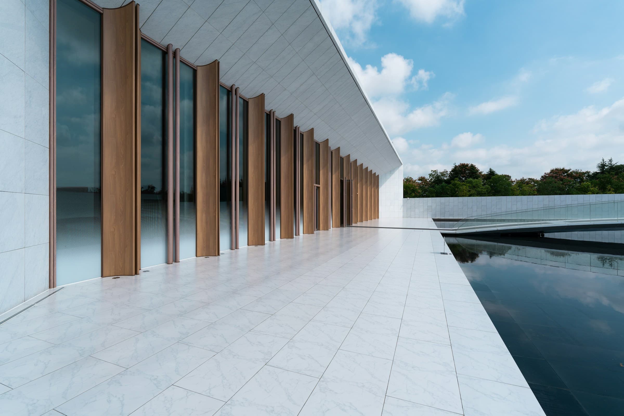 Premium modern building with timber columns and reflective pool, MDC Living